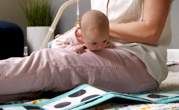 Baby doing tummy time while looking at the Black & White Card Set from The Looker Play Kit