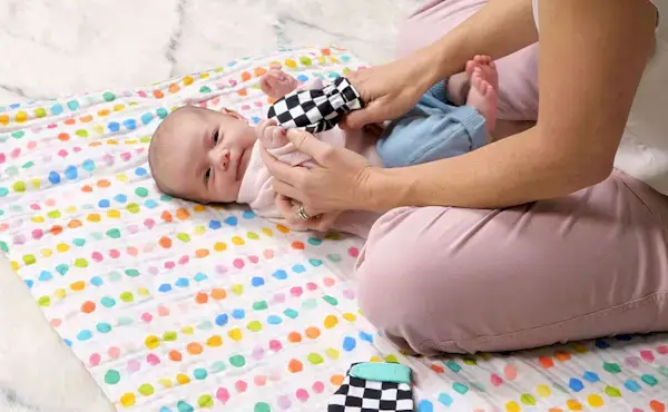 Mother playing with the Black & White Mittens from The Looker Play Kit with her baby