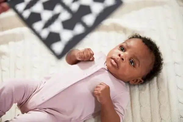 Baby laying on the ground looking up at the Black and White Contrast Cards by Mommy's Reviews