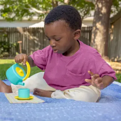 Little boy pouring water from the Pinkies Up Picnic Set from The Enthusiast Play Kit