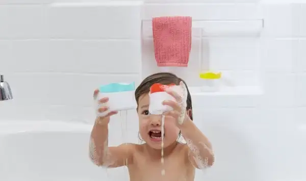 Young child in a tub playing with toys by Mommy's Reviews