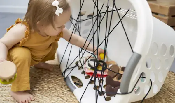Child grabbing things out of a laundry basket