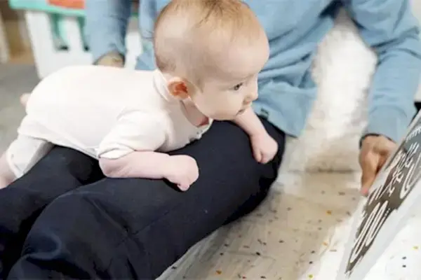 Baby doing tummy time on a woman