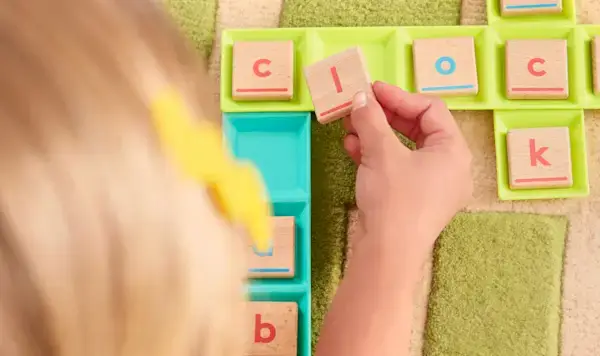 Child playing with the Sound Swap & Drop from The Reading Skill Set Part 2: Words to Books