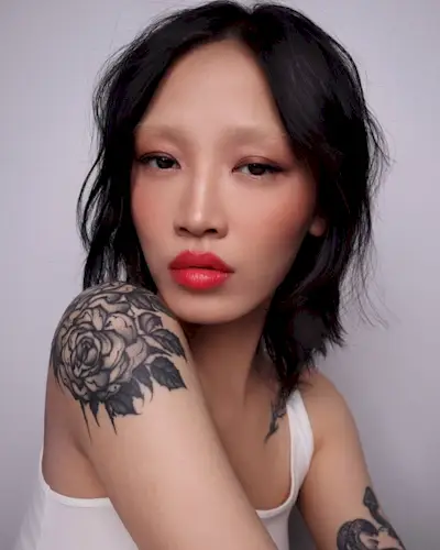 Woman wearing her hair styled with tousled waves and a middle part.