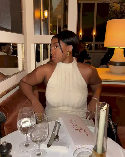 @nnennaechem in a restaurant with a chic updo hairstyle