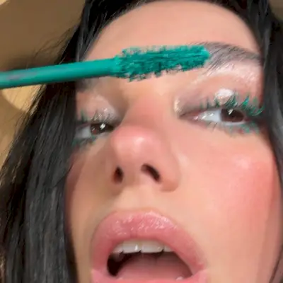 Dua Lipa wearing turquoise mascara