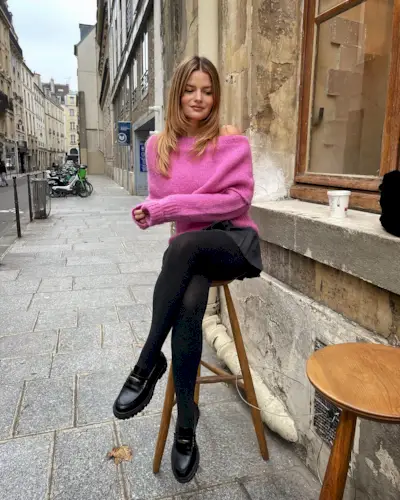 @sabinasocol sitting on a stool in Paris with a '90s layered haircut