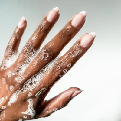 Hand showcasing soap nails.