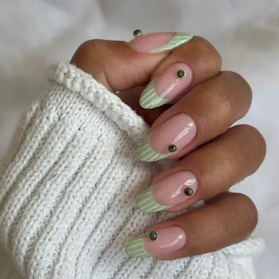 Striped French tip nails with mini 3D olives decals.