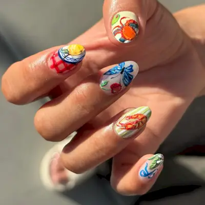 Mismatched summer nails with fruit, bows, and crustaceans.
