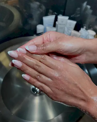 Iram Shelton wearing classic French tip manicure trend