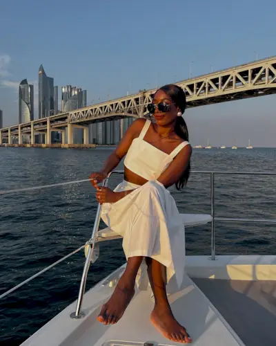 @aidabadji_ sitting on a boat with a milky pedicure