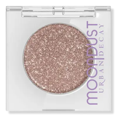 Sabrina Carpenter posing in front of a ski lift wearing a blue snowflake dress and fairy dust eye shadow.