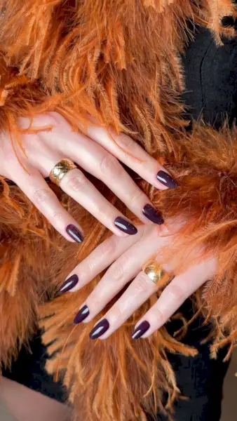 An image of a plum manicure, one of the most popular nail colours.