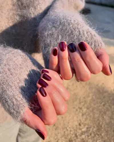 An image of a plum manicure, one of the most popular nail colours.