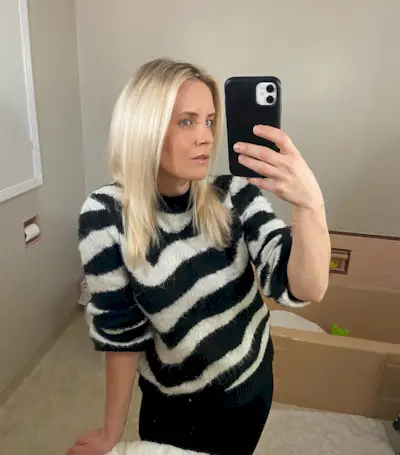 Woman with fine, curly hair after testing the Revlon One Step Dryer