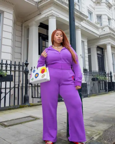 @laurennicolefk in a purple tracksuit with auburn hair