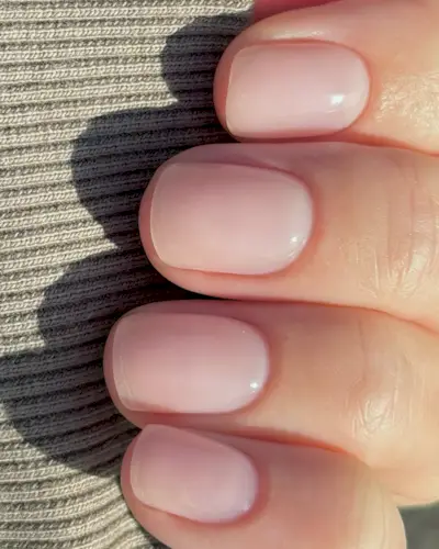 A short, slightly rounded sheer manicure look