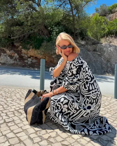 woman with short hair wearing a printed dress