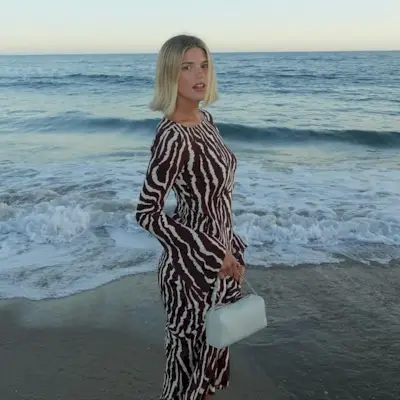 woman with short hair in a dress at the beach