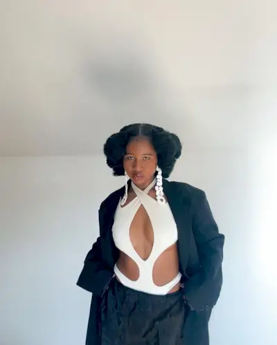 woman with cut-out shirt and short hair