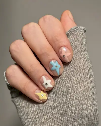 Nude nails with pastel stars.