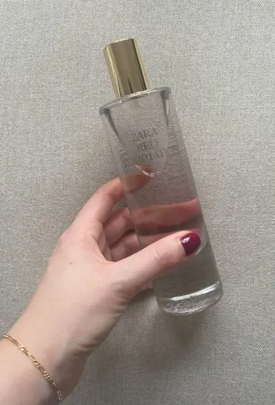 Grace holding a bottle of Zara Red Temptation
