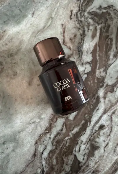 A picture of Zara cocoa latte perfume on a marble surface