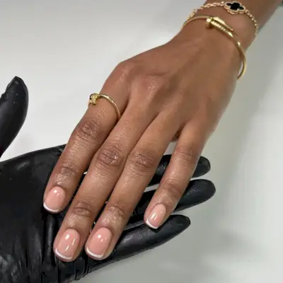 A short, square, glass-like French manicure