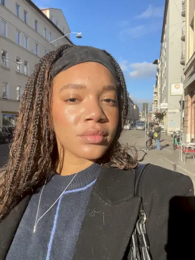 An image of Mommy's Reviews UK Junior Fashion Editor Imani-Nia Francis-Tsolaki wearing her most-complimented perfume.