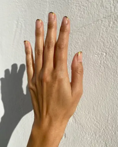 Metallic gold short French tip nails