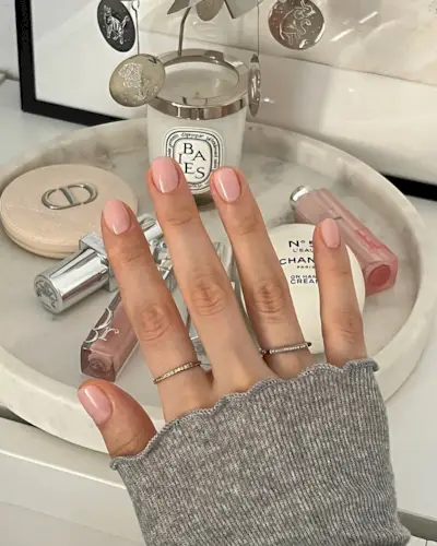 A woman wearing Essie's Sheer Fantasy nail polish