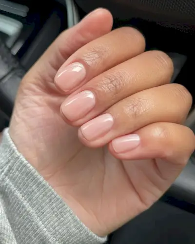 A woman wearing Essie's To The Rescue nail polish