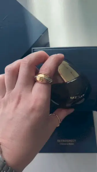 Woman sitting next to a statue next to a pond