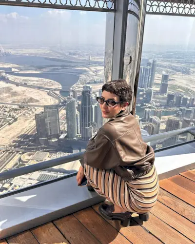 A woman with a curly, classic pixie haircut