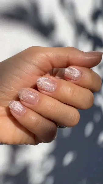 A close-up of a sheer cat-eye manicure