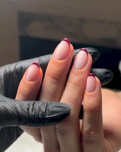 Dark red French manicure.