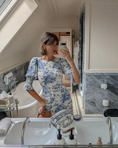 A woman taking a selfie with a half-up, half-down bob hairstyle