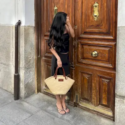 Woman posing in front of a door with long hair