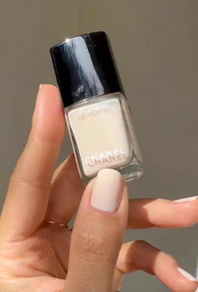 Light sheer yellow nail polish on squoval nails