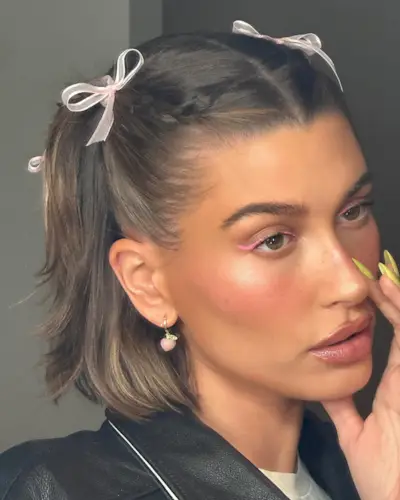 Hailey Bieber with braided pigtails and bows
