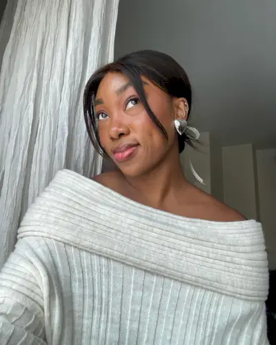 a woman taking a selfie with an elegant hairstyle