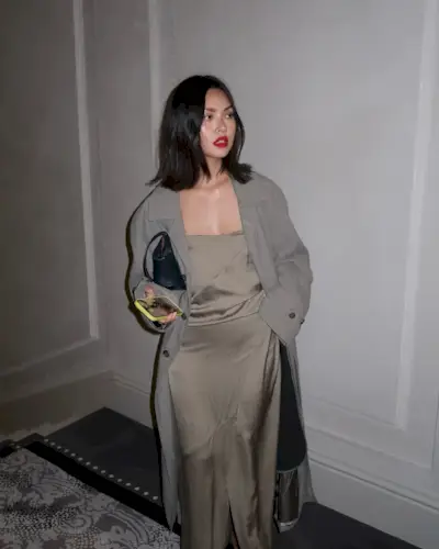 A woman with a short, naturally wavy hairstyle.