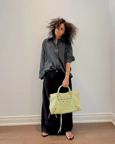 A woman with a curly, short hairstyle.