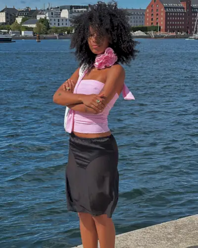 A woman with a shoulder-length Afro hairstyle.