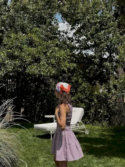 A woman with a short hairstyle and scarf in her hair.