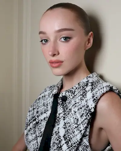 Phoebe Dynevor wearing a slicked-back bun.