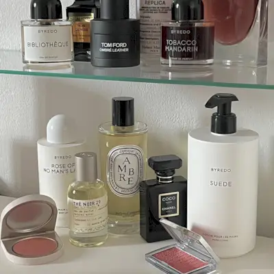 Photo of perfumes on a bathroom shelf