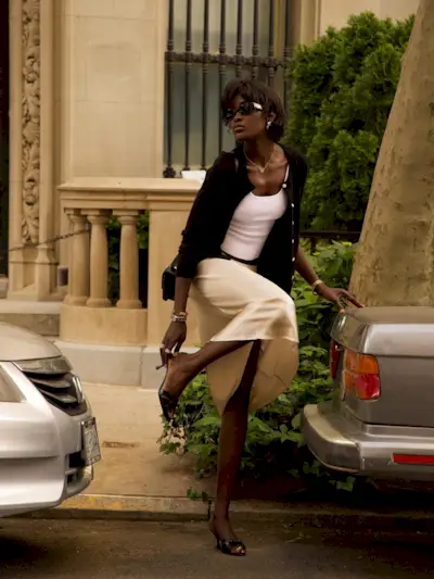 A woman posing in the street with a shaggy bob hairstyle